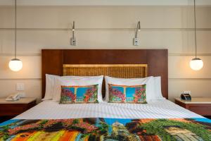 a bedroom with a large bed with two pillows at Hotel Dann Cartagena in Cartagena de Indias