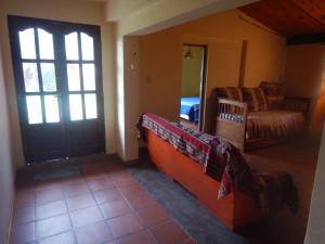 a living room with a door and a couch at Jujuy Casa Pueblo in Reyes