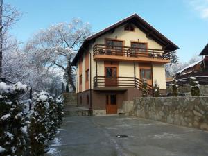 a house with a balcony on top of it at Casa Teju 2 in Slănic