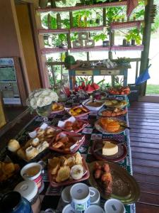 stół z wieloma różnymi rodzajami żywności w obiekcie Pousada Estância Macaúbas - w mieście São Roque de Minas