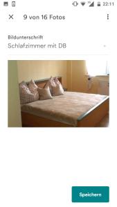 a bedroom with a bed with pillows on it at Fewo Hilde in Annenheim
