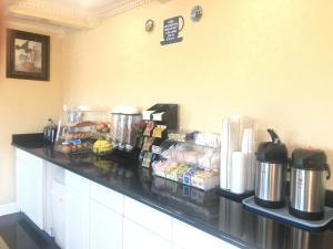 a kitchen with a counter top with food on it at Travelodge by Wyndham Orangeburg in Orangeburg
