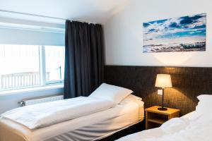 Una cama o camas en una habitación de Litli Geysir Hotel