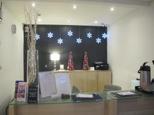 a desk in an office with christmas decorations on a wall at Alhambra Hotel in London