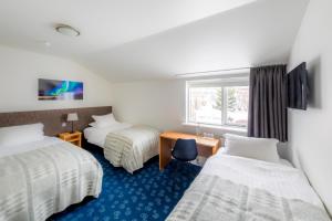 Säng eller sängar i ett rum på Litli Geysir Hotel
