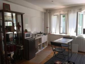 a kitchen with a table and a chair in a room at Villa Cemaste in Montpellier