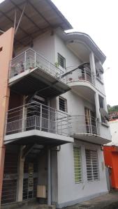 a white building with balconies on the side of it at Fleur PATESA in Fort-de-France