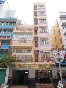 a tall building with a balcony in front of it at Huynh Lac Can Tho Hotel in Can Tho