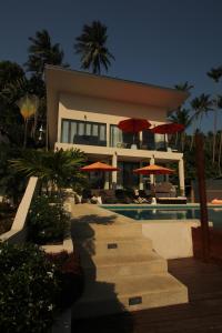 a house with a swimming pool next to a resort at Baan Seaview Holiday Villas in Lamai +26 photos