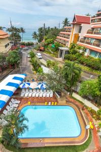 an overhead view of a swimming pool with chairs and umbrellas at PorterHouse Beach Hotel in Patong Beach