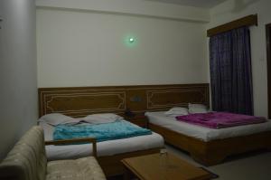 Ένα ή περισσότερα κρεβάτια σε δωμάτιο στο Hotel Quality Home