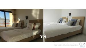 two beds in a room next to each other at Quarteira Paul Harris Apartment in Quarteira