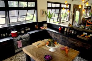 a kitchen with a wooden table and some windows at Holiday beautiful Villa 4 Bedroom Garden View Canggu in Canggu