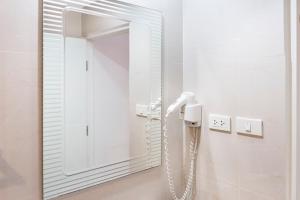 a bathroom with a mirror and a telephone at Sunny Beach Residence in Jomtien Beach