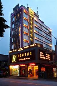 a large building with lights on the front of it at Guangzhou The Royal Garden Hotel in Guangzhou