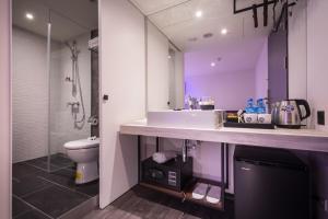 a bathroom with a sink and a toilet at Goldinn Hotel in Taipei