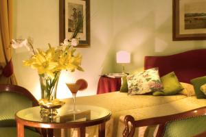 a room with a table with a vase of flowers on it at JOIVY Together Florence Secret Nest in Florence