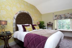 a bedroom with a large bed with purple and yellow walls at Rockhill House in Letterkenny +50 photos