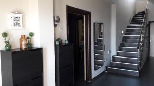 a hallway with a staircase and a mirror next to a door at Villa Iris in Livadi