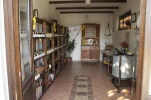 a room with a kitchen with shelves of wine bottles at El Garbin in Savigliano