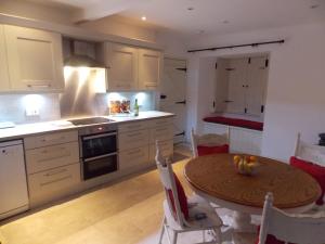 a kitchen with a table and a dining room at Hilltop Cottage, Barnard Castle in Barnard Castle