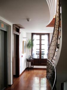 a hallway with a spiral staircase in a house at La Plaza I in Luanco
