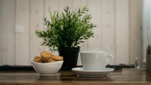 two cups of coffee and a bowl of food on a table at The Mint Villa - Saint Vlas in Sveti Vlas