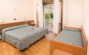 Postel nebo postele na pokoji v ubytování Hotel Trevi