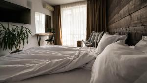 a bedroom with a large white bed with a wooden headboard at The Mint Villa - Saint Vlas in Sveti Vlas +31 photos