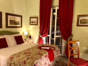 a bedroom with a bed and a window with red curtains at JOIVY Together Florence Secret Nest in Florence