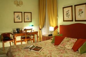 a hotel room with a bed with a book on it at JOIVY Together Florence Secret Nest in Florence