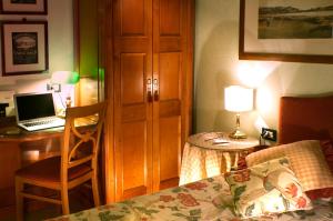 a bedroom with a bed and a desk with a laptop at JOIVY Together Florence Secret Nest in Florence