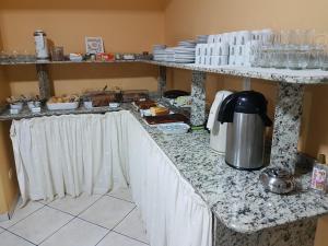 a kitchen with a counter top with a coffee maker on it at Hotel Nevada in Cascavel