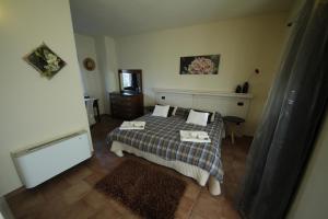 a bedroom with a bed with two towels on it at Agriturismo Tra Serra E Lago in Roppolo