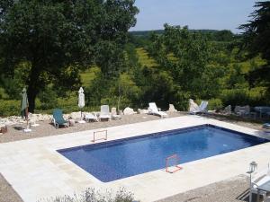 a swimming pool in a yard with lounge chairs at les mondains in Margueron