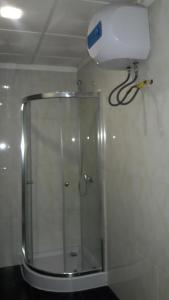 a shower in a bathroom with a light on the ceiling at Apartamentos Santiago - Praia in Praia +39 photos