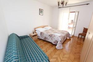 a bedroom with a bed and a mirror in it at Apartments Milka in Rovinj
