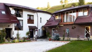 a white house with a red roof at Casa Maria in Bran