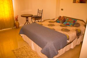 מיטה או מיטות בחדר ב-Hostal Quinta Normal
