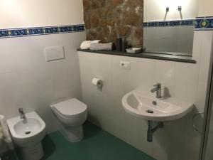 a bathroom with a toilet and a sink at Palazzo Urbani in Orvieto +17 photos