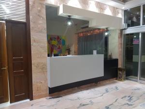 a white counter in a room with a wall at Hotel Bella Riva Kinshasa in Kinshasa