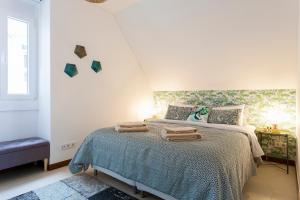a bedroom with a bed with towels on it at bairro alto view point 3 bedrooms chalet in Lisbon +26 photos
