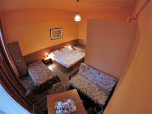 a room with a bed and two chairs and a table at Pension Madara in Vienna