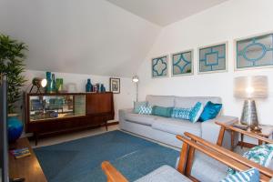 a living room with a couch and a table at bairro alto view point 3 bedrooms chalet in Lisbon