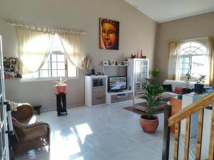 a living room with a couch and a television at Casa Papi in Lajares