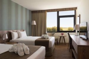 Postel nebo postele na pokoji v ubytování Salinas del Almiron Resort Termal