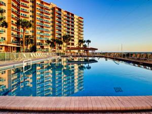 a swimming pool in front of a large building at Regatta Beach Club C1009 2373 in Clearwater Beach