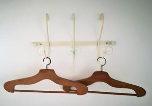 two wooden hangers hanging on a wall at Casinhas da Ajuda nº25 in Lisbon