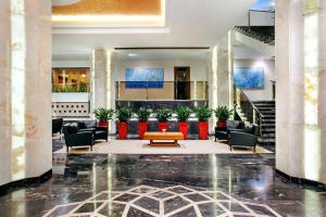a lobby of a hotel with couches and a table at Novotel Sarajevo Bristol in Sarajevo
