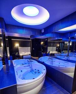 a large bathroom with two tubs in a room at Atlantic Hotel in Athens